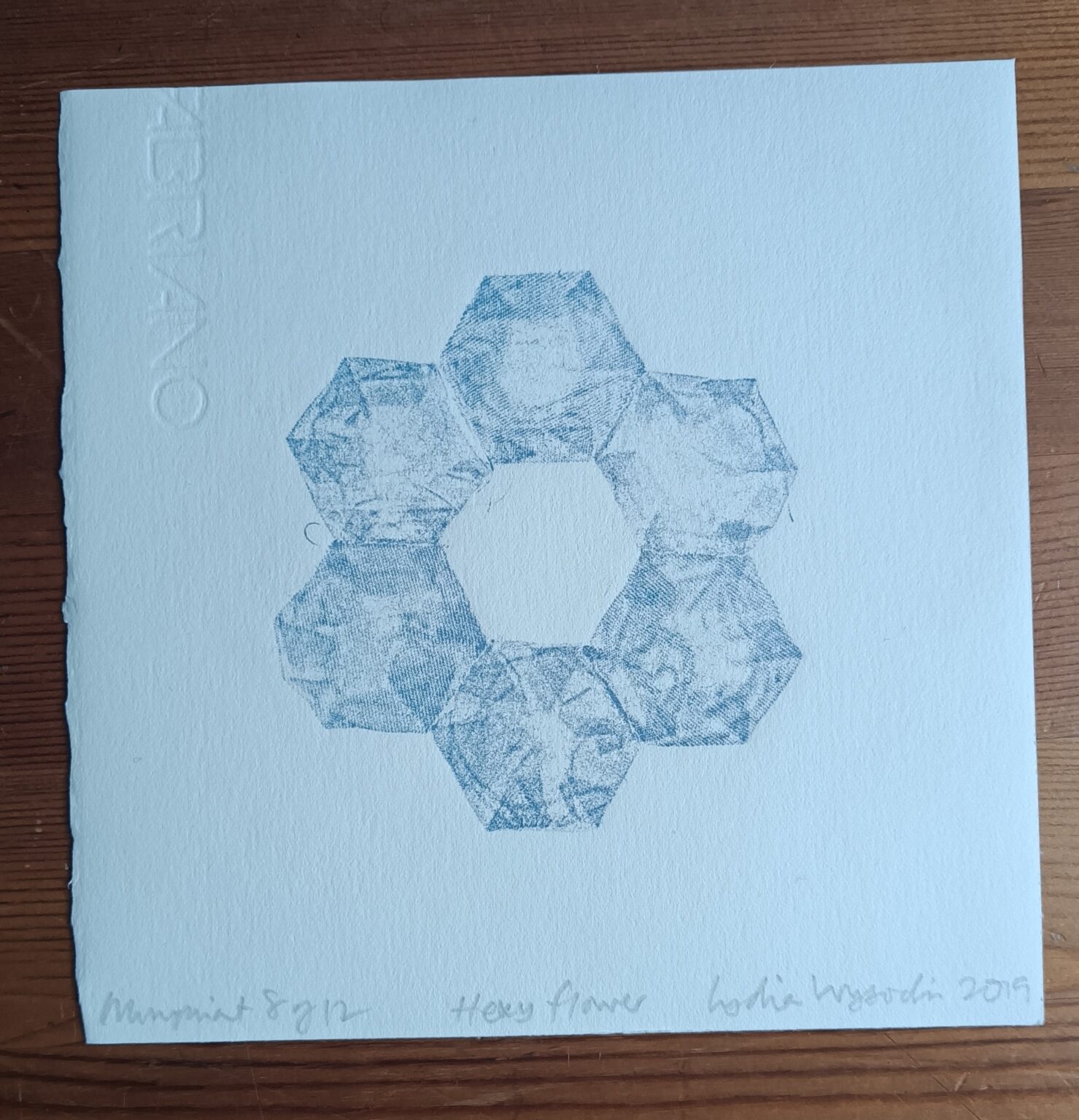 photo of patchwork monoprint of a blue flower made from six hexagons