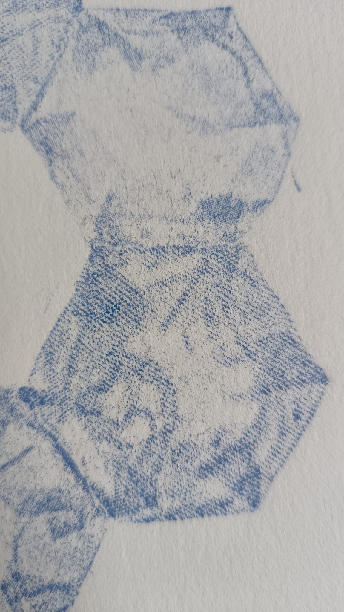 close-up showing texture printed from fabric onto paper, blue